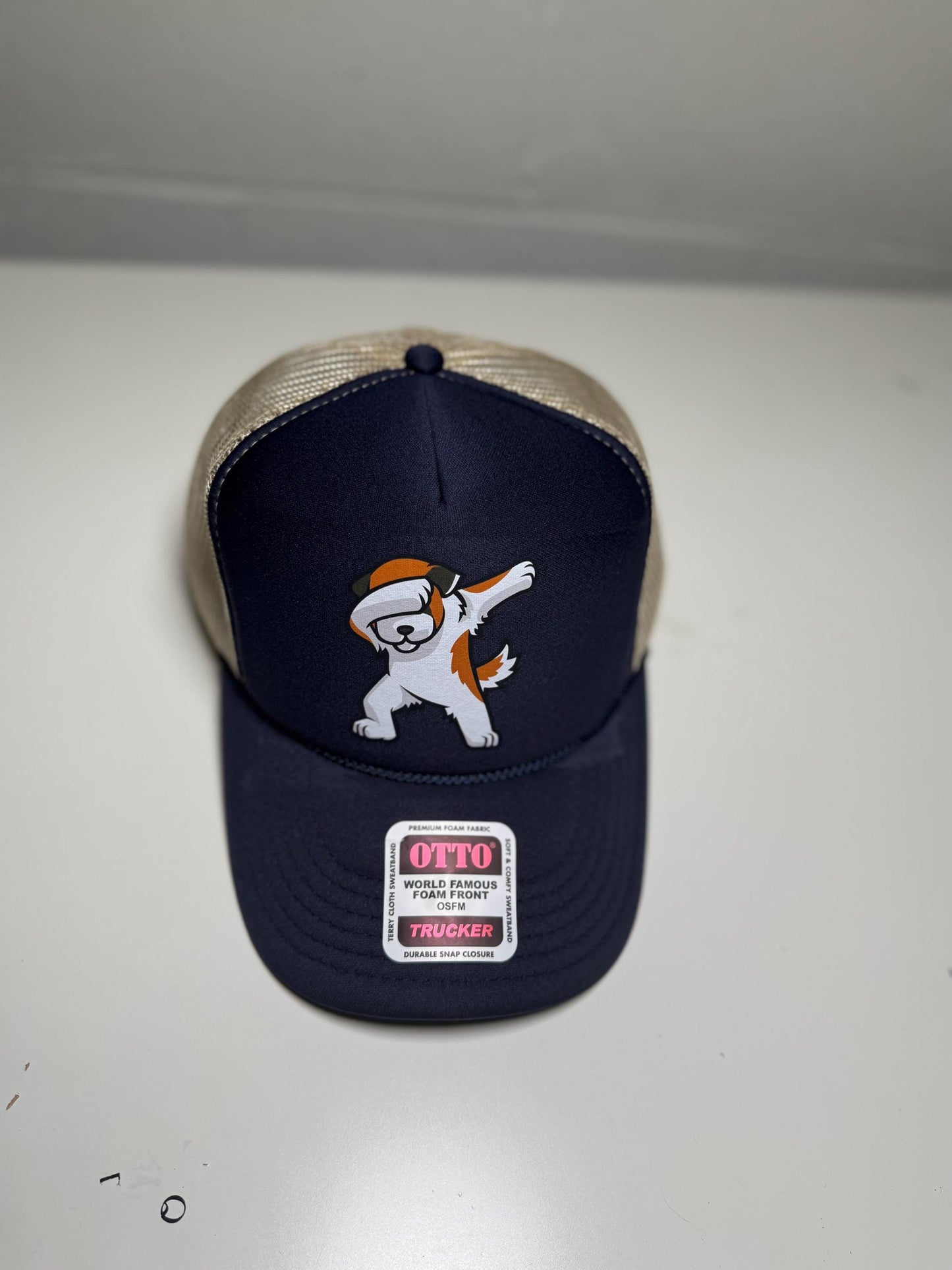 Navy blue cap with cartoon character and 'Otto' label on a white background