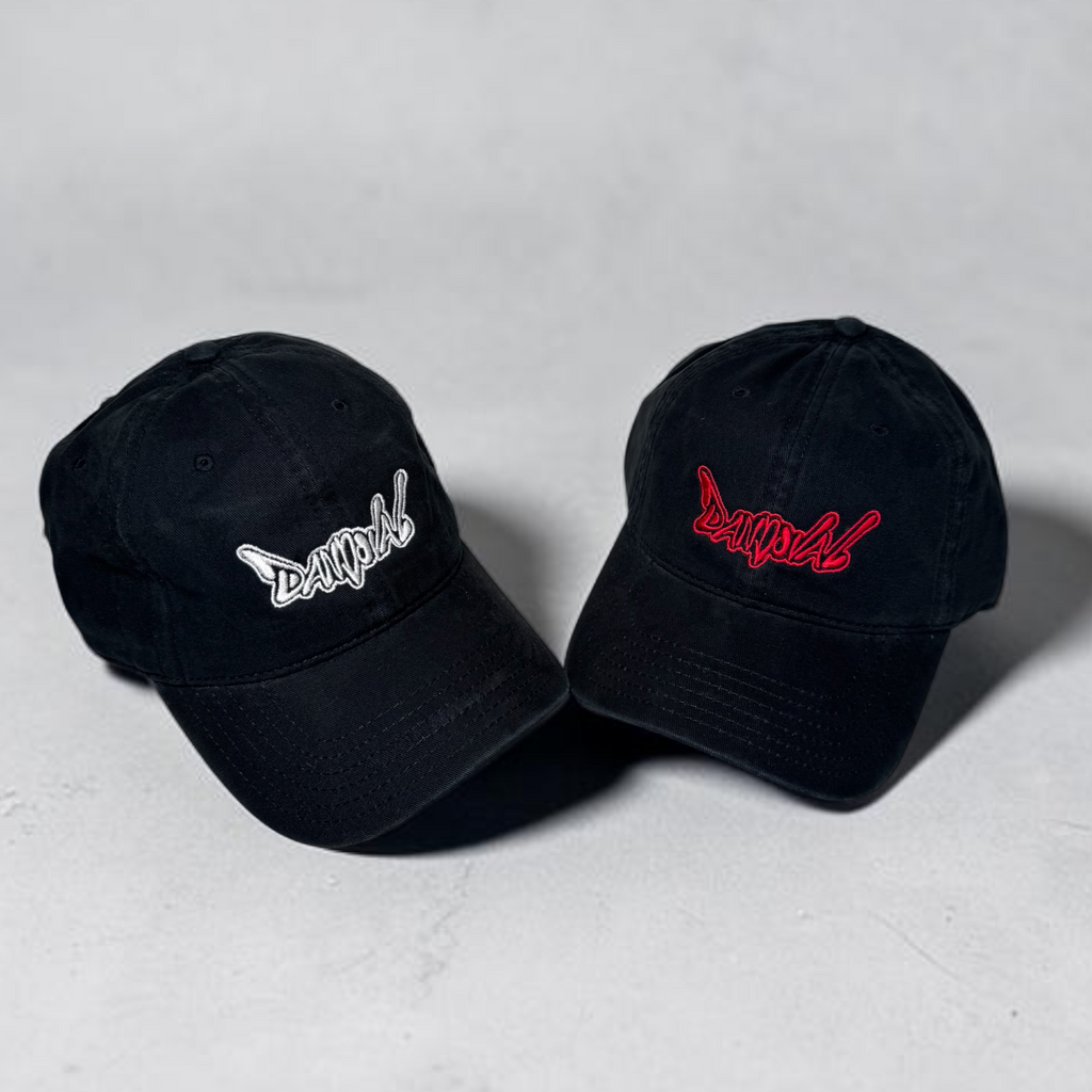 Two black baseball caps with embroidered logos on a light gray background
