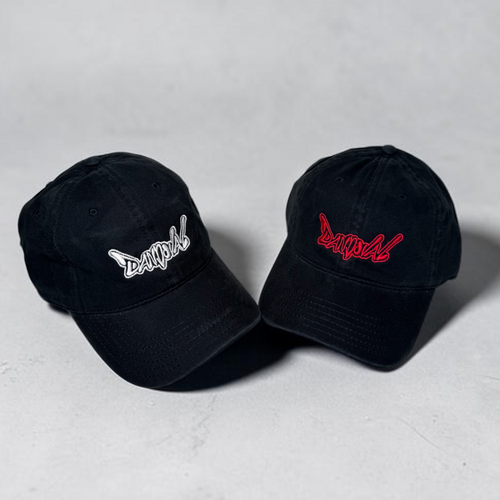 Two black baseball caps with embroidered logos on a light gray background