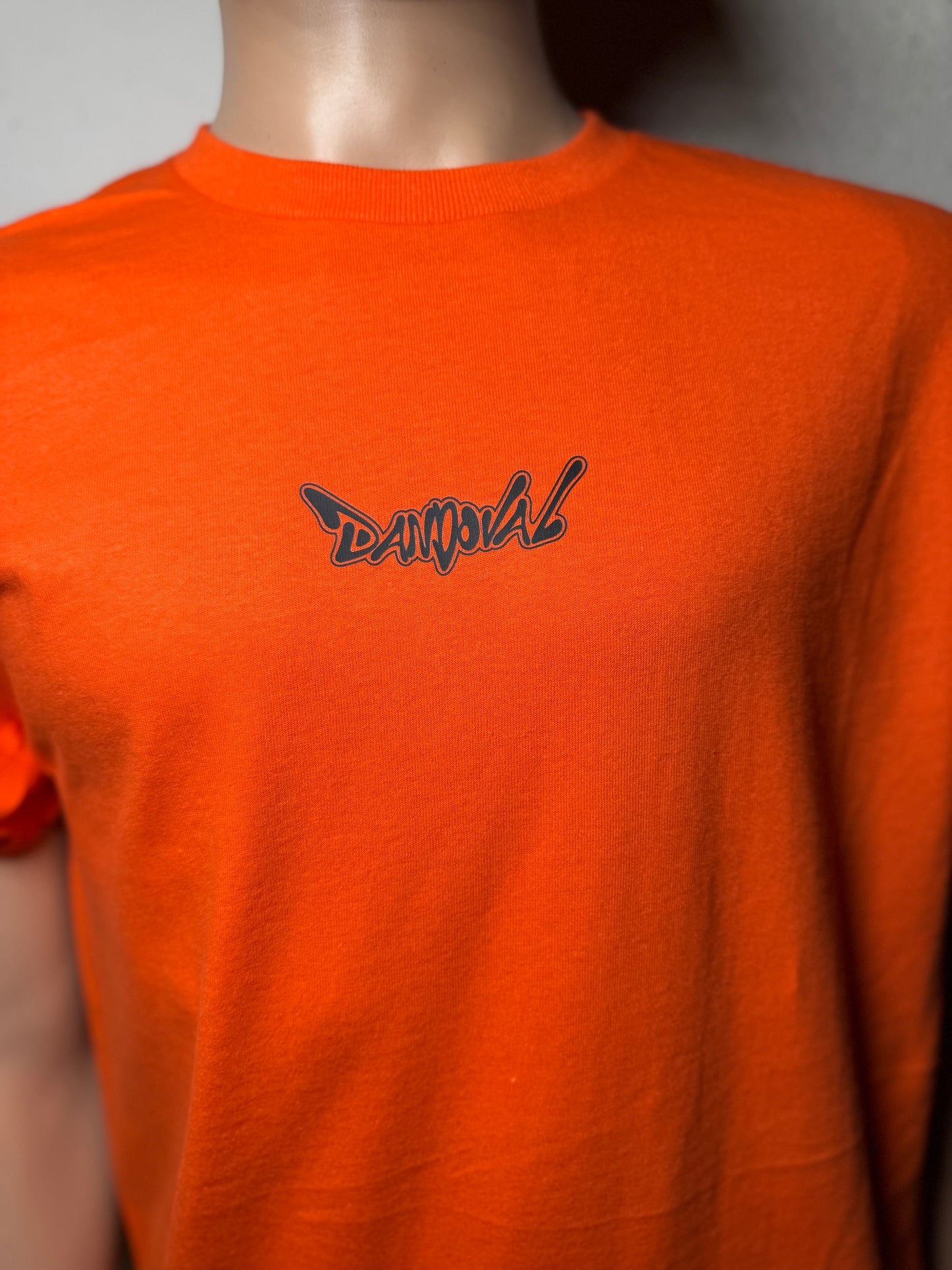 "DANDOVAL OG Logo T-Shirt in white, showcasing comfortable 4.3 oz. combed ringspun cotton fabric and iconic OG logo design."