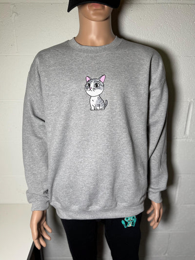 Gray sweatshirt with a cartoon cat design on a mannequin against a plain background