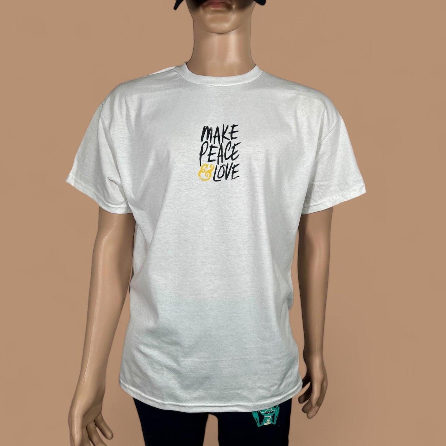 White t-shirt with 'Make Peace Love' text on a brown background