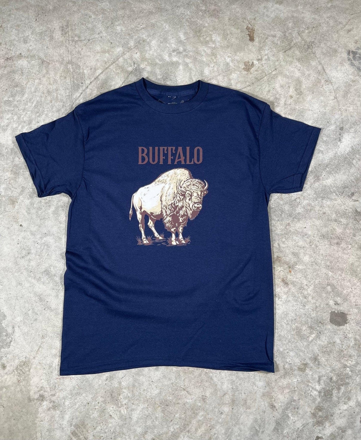 Navy blue t-shirt with a graphic of a buffalo and the word 'Buffalo' on a textured surface.