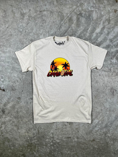 Sand t-shirt with a colorful graphic design on a gray surface