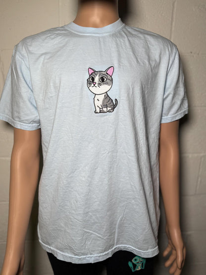 Gray t-shirt with a cartoon cat design on a mannequin against a plain background