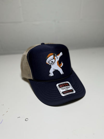 Navy blue cap with cartoon character and beige visor on a white surface