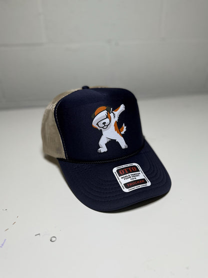 Navy blue cap with cartoon character and beige visor on a white surface