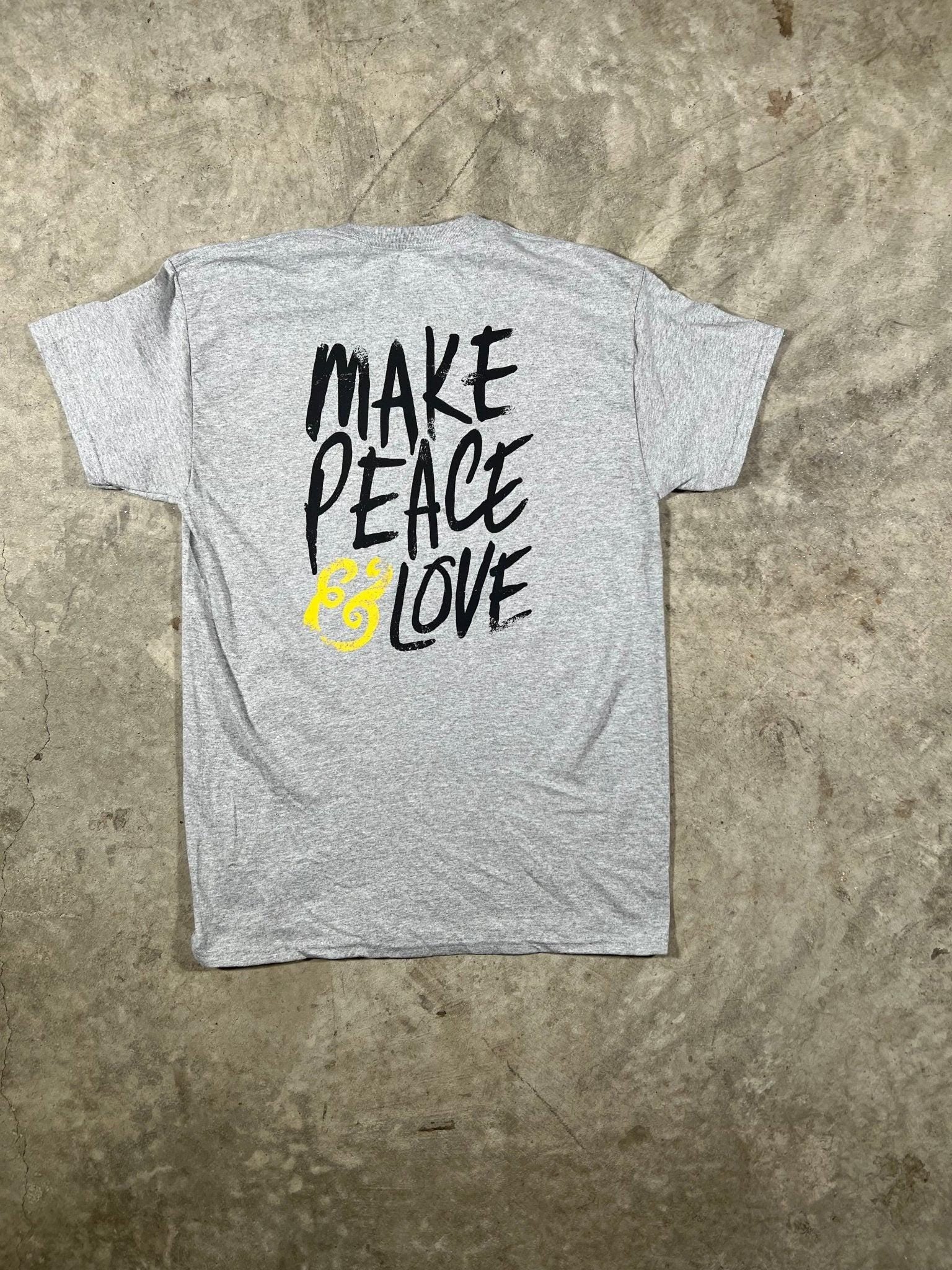 Gray t-shirt with 'Make Peace Love' text on a textured surface