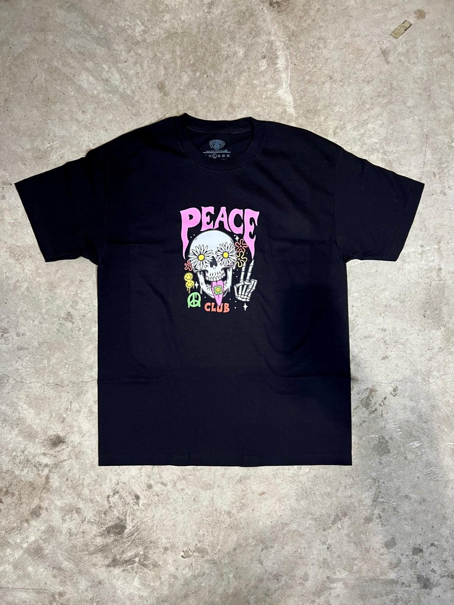 Black t-shirt with a colorful graphic design on a textured gray surface