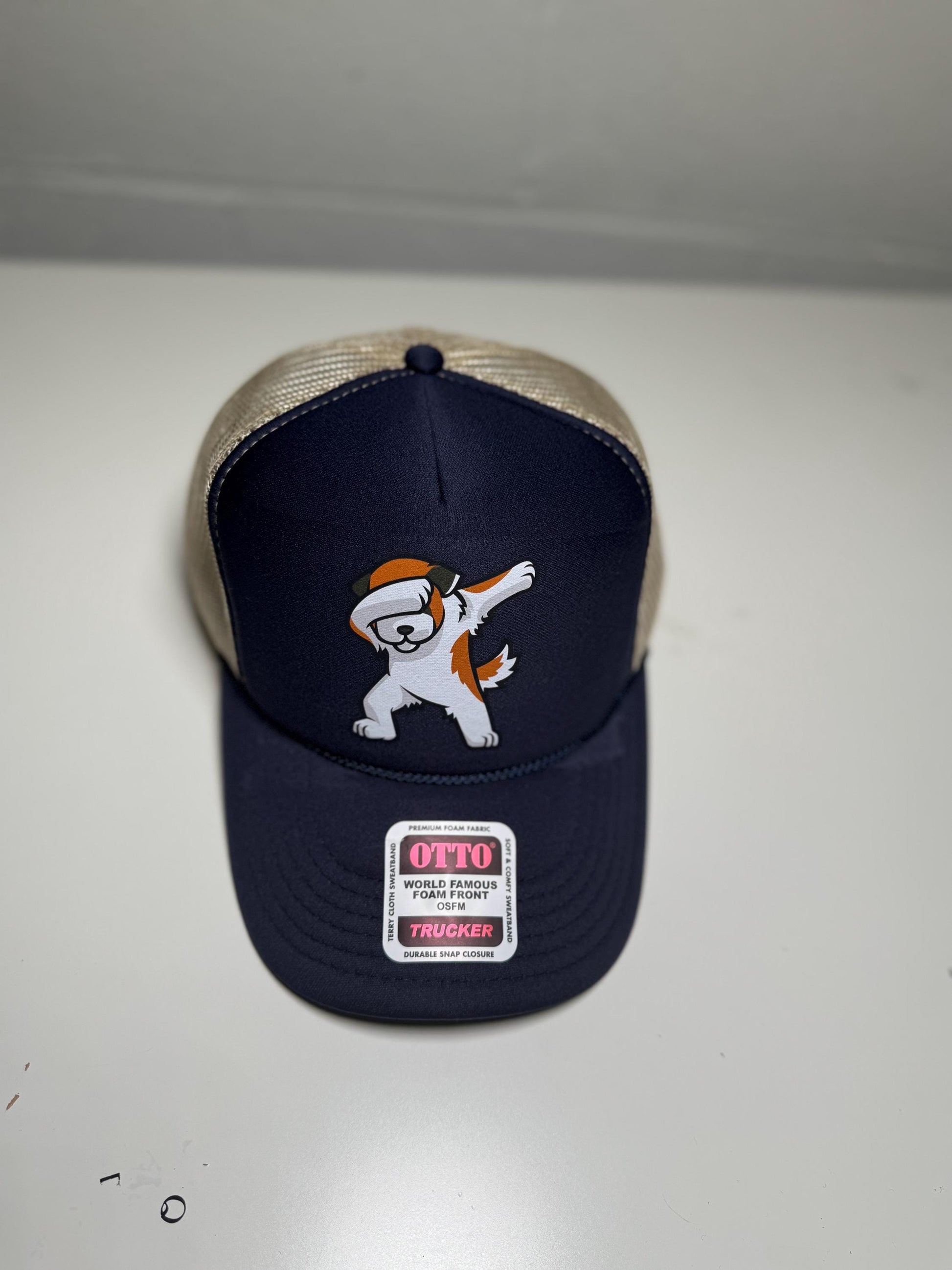 Navy blue cap with cartoon character and 'Otto' label on a white background