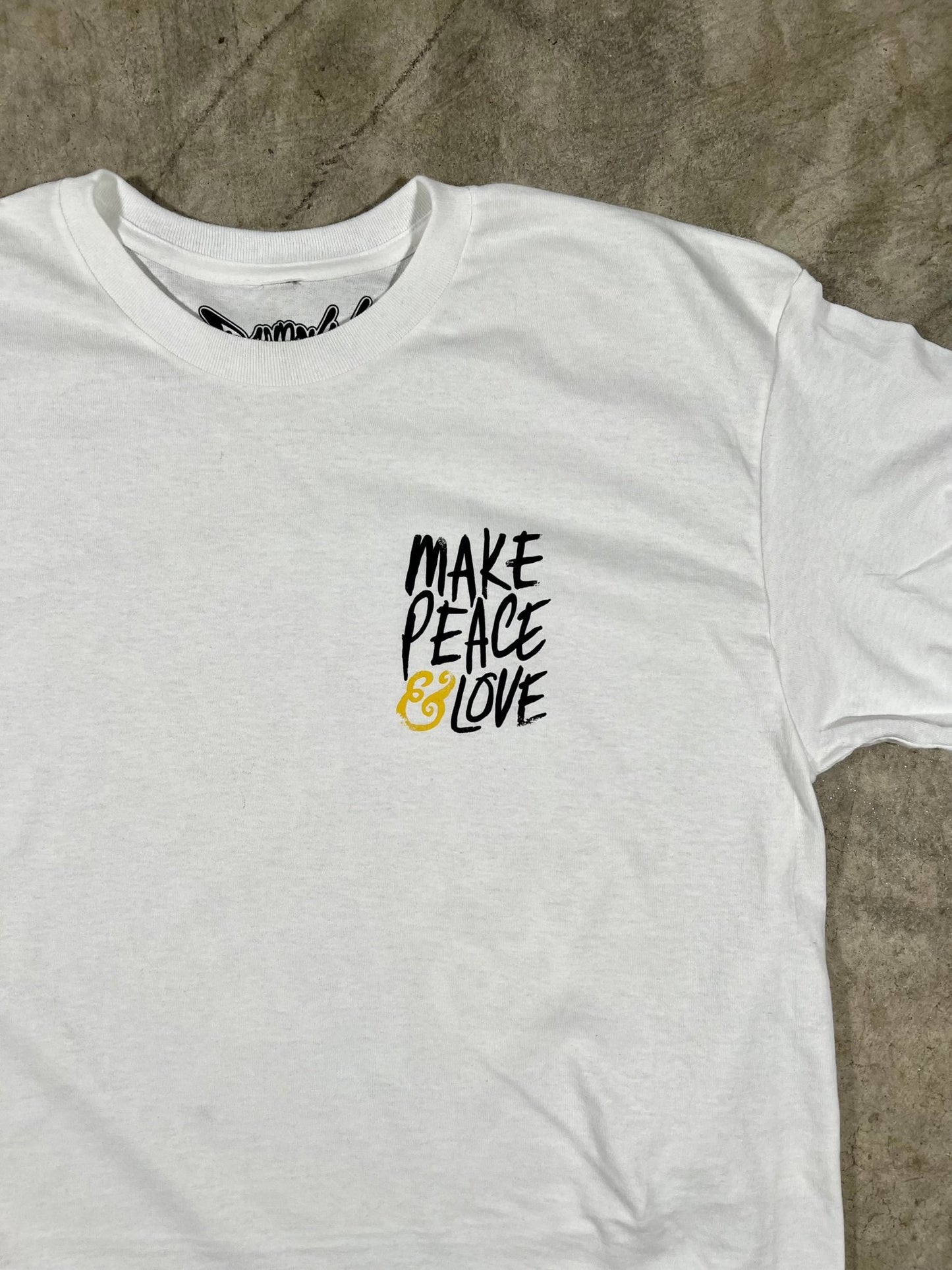 "Close-up of the soft and comfortable 100% combed ringspun cotton fabric of the MAKE PEACE & LOVE T-Shirt."